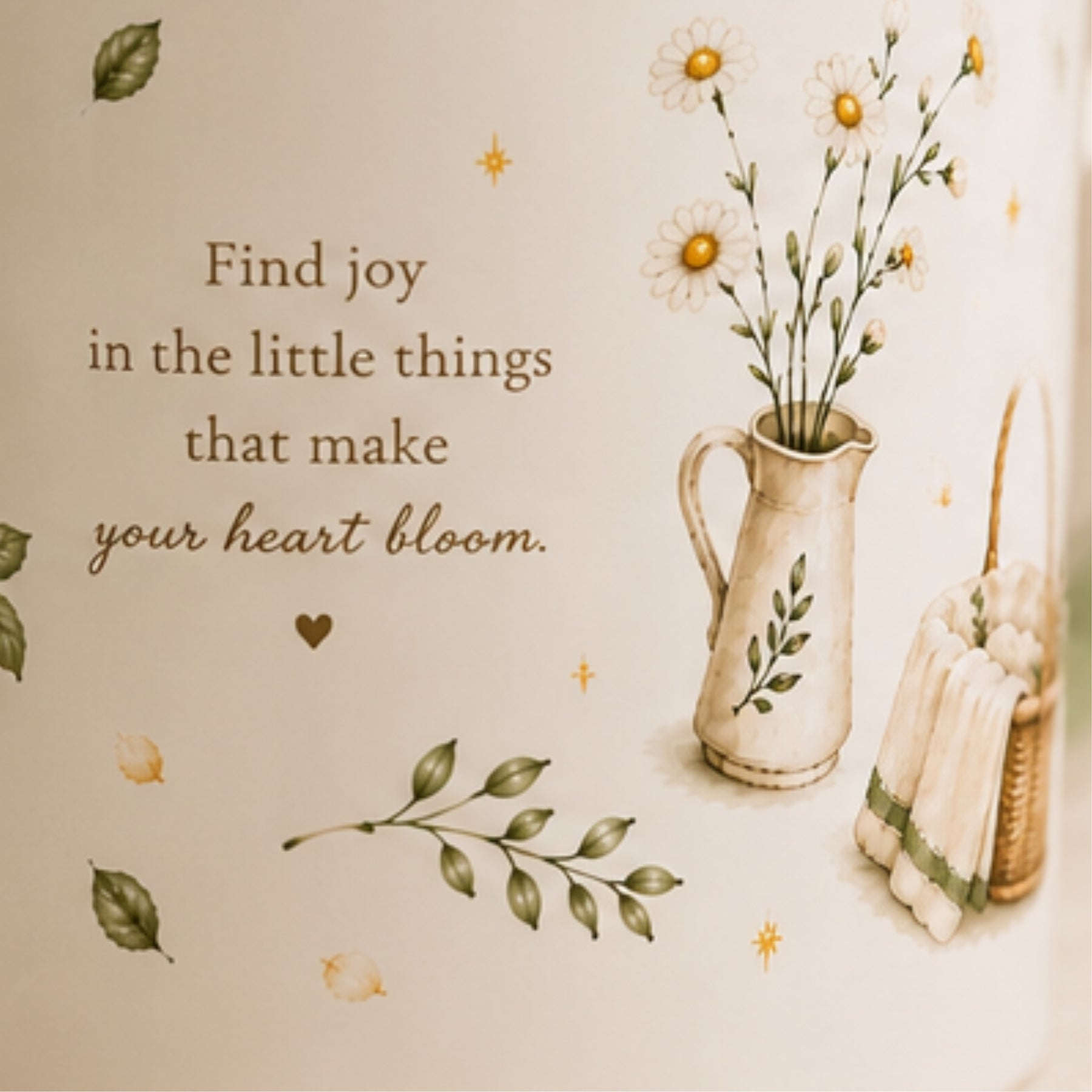 A cream-colored wall decal or art print featuring a cozy, vintage-style illustration. The design includes the quote 'Find joy in the little things that make your heart bloom.