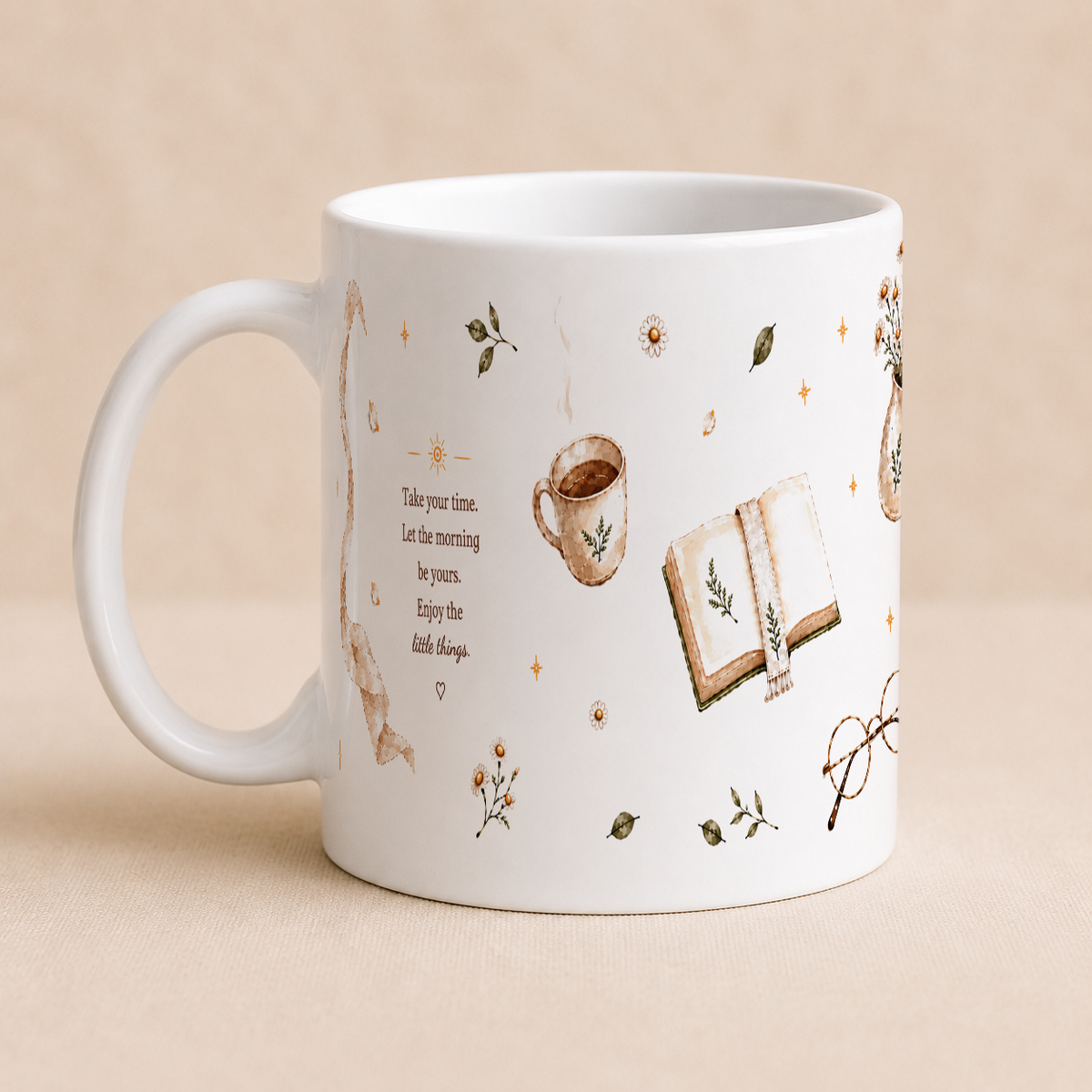 A white ceramic mug with a handle, decorated with brown watercolor-style illustrations of a book, coffee cup, glasses, leaves, and small text, set against a warm beige background.